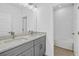Well-lit bathroom featuring a double sink vanity and separate toilet at 13817 Luna Harvest Ave, Winter Garden, FL 34787