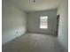 This bedroom has a neutral paint and a bright window at 13817 Luna Harvest Ave, Winter Garden, FL 34787