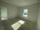 This bedroom has a neutral paint and a bright window at 13817 Luna Harvest Ave, Winter Garden, FL 34787