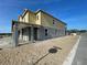 Side view of new home under construction with yellow siding and gray trim, featuring a covered porch and multiple windows at 13817 Luna Harvest Ave, Winter Garden, FL 34787