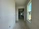 Bright hallway featuring natural light from window, with a view into other rooms under construction at 13817 Luna Harvest Ave, Winter Garden, FL 34787