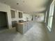 Spacious kitchen with an island and modern gray cabinets ready for appliances in a bright, open-concept layout at 13817 Luna Harvest Ave, Winter Garden, FL 34787