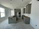 New kitchen features gray cabinets, an island, and recessed lighting; awaiting final touches and appliances at 13817 Luna Harvest Ave, Winter Garden, FL 34787