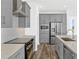 Bright kitchen with stainless steel appliances, gray cabinetry, granite countertops, and modern finishes at 13817 Luna Harvest Ave, Winter Garden, FL 34787