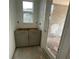 Laundry room with gray cabinets and a sliding glass door to the outside at 13817 Luna Harvest Ave, Winter Garden, FL 34787