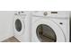 Bright laundry room featuring a modern washer and dryer unit at 13817 Luna Harvest Ave, Winter Garden, FL 34787