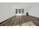 Bright and spacious living room featuring wood-look floors, large windows, and modern finishes at 13817 Luna Harvest Ave, Winter Garden, FL 34787