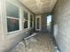 A covered patio boasts a smooth ceiling and is ready for customization and enjoyment at 13817 Luna Harvest Ave, Winter Garden, FL 34787