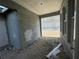 A covered patio with smooth ceilings leads to a spacious garage area at 13817 Luna Harvest Ave, Winter Garden, FL 34787
