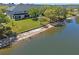Aerial view of the townhome with a lake, beach, and green lawn at 13832 Dove Wing Ct, Orlando, FL 32828