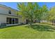Spacious backyard with lush green grass and mature trees surrounding the property at 13832 Dove Wing Ct, Orlando, FL 32828