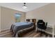 Bedroom with neutral walls, wood-look floors and a window with natural light at 13832 Dove Wing Ct, Orlando, FL 32828
