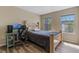 Bedroom with neutral walls, wood-look floors and two windows with natural light at 13832 Dove Wing Ct, Orlando, FL 32828