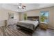 Bedroom with wood-look flooring, neutral walls, a ceiling fan and views to the water at 13832 Dove Wing Ct, Orlando, FL 32828
