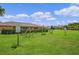 Outdoor exercise area with adult workout equipment surrounded by green lawns and landscaping at 13832 Dove Wing Ct, Orlando, FL 32828
