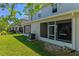 Townhome exterior featuring a well-manicured lawn and screened-in patio at 13832 Dove Wing Ct, Orlando, FL 32828