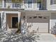 Charming townhome showcasing a convenient front entry garage and private front door entrance at 13832 Dove Wing Ct, Orlando, FL 32828