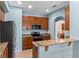 Stylish kitchen featuring granite countertops, wood cabinets, and stainless appliances at 13832 Dove Wing Ct, Orlando, FL 32828