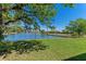 Picturesque view of the lake with a fountain, framed by a lush green lawn at 13832 Dove Wing Ct, Orlando, FL 32828