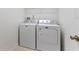 Laundry room with white walls and white washer and dryer at 13832 Dove Wing Ct, Orlando, FL 32828