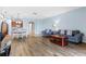 Open-concept living room with wood floors and a view of the kitchen at 13832 Dove Wing Ct, Orlando, FL 32828