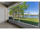 Relaxing screened patio view overlooking the serene lake and lush greenery at 13832 Dove Wing Ct, Orlando, FL 32828