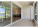 Screened porch with views to a lake and a glimpse into the living room at 13832 Dove Wing Ct, Orlando, FL 32828