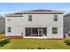 Large backyard with a screened-in patio, well-maintained lawn, and solar panels on the roof at 1395 Olympic Club Blvd, Champions Gate, FL 33896