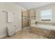Bright bathroom featuring walk-in shower, soaking tub, and neutral tile at 1395 Olympic Club Blvd, Champions Gate, FL 33896