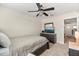 Bright bedroom with a ceiling fan, a dresser with a TV, and a view to the landing area at 1395 Olympic Club Blvd, Champions Gate, FL 33896