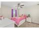bedroom with plush toys and a pink comforter. Lots of natural light from the window at 1395 Olympic Club Blvd, Champions Gate, FL 33896
