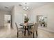 Cozy dining area featuring a round table with seating for four and a modern chandelier at 1395 Olympic Club Blvd, Champions Gate, FL 33896