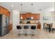 Well-equipped kitchen with stainless steel appliances, a central island, and counter seating, blending style and functionality at 1395 Olympic Club Blvd, Champions Gate, FL 33896