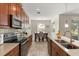 Elegant kitchen with stylish countertops, stainless steel appliances, and a view into the dining area at 1395 Olympic Club Blvd, Champions Gate, FL 33896