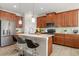 Modern kitchen featuring stainless steel appliances, a large island with seating, and ample cabinet space at 1395 Olympic Club Blvd, Champions Gate, FL 33896