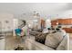 Spacious living room seamlessly connects to the kitchen, creating an inviting open-concept layout perfect for gatherings at 1395 Olympic Club Blvd, Champions Gate, FL 33896