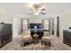 Serene main bedroom featuring a king bed, neutral color palette, and a decorative ceiling fan at 1395 Olympic Club Blvd, Champions Gate, FL 33896