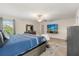 Stylish main bedroom with a king-size bed, modern decor, and a mounted TV at 1395 Olympic Club Blvd, Champions Gate, FL 33896