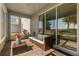 Cozy covered patio with comfortable seating and a view of the landscaped backyard and natural light at 1395 Olympic Club Blvd, Champions Gate, FL 33896