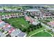 An aerial view shows an attractive residential neighborhood with a community green space and mature trees at 15149 Canoe Pl, Winter Garden, FL 34787