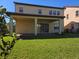 Spacious backyard with lush green lawn and covered patio perfect for outdoor entertaining with room for dining and lounging at 15149 Canoe Pl, Winter Garden, FL 34787