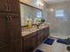 Bathroom features double sinks, granite countertops, and a glass-enclosed shower at 15149 Canoe Pl, Winter Garden, FL 34787