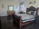 Bedroom featuring a dark wood, ornate bed frame, matching dressers and dark hardwood flooring at 15149 Canoe Pl, Winter Garden, FL 34787