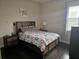 Bedroom featuring a full bed, wood floors and side tables with a window providing ample light at 15149 Canoe Pl, Winter Garden, FL 34787