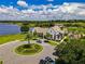 A clubhouse with a circular driveway and attractive landscaping provides a gathering place for the community at 15149 Canoe Pl, Winter Garden, FL 34787