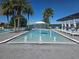 Zero-entry pool and water fountains surrounded by palm trees and lounge chairs showcasing a luxurious and inviting community space at 15149 Canoe Pl, Winter Garden, FL 34787