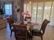 Dining room boasts a glass table, seating for four, tile floors and bright window light at 15149 Canoe Pl, Winter Garden, FL 34787