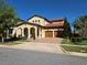 Beautiful two-story home featuring a red tile roof, arched entryway, a three-car garage, and manicured landscaping at 15149 Canoe Pl, Winter Garden, FL 34787