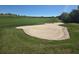 Picturesque view of the golf course, highlighting the sand trap and the community's recreational amenities at 15149 Canoe Pl, Winter Garden, FL 34787