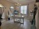 Bright home office featuring neutral colors, a modern desk, decorative vases, and ample natural light at 15149 Canoe Pl, Winter Garden, FL 34787